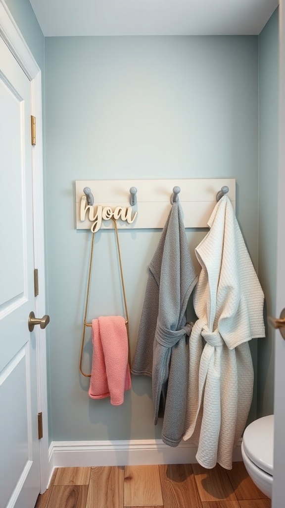 Personalized name hooks in a kids' bathroom with towels hanging on them